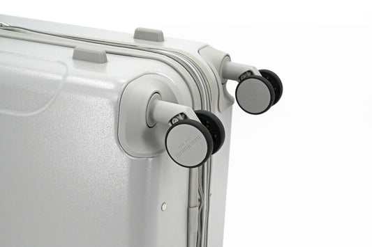 Set of three blue suitcases with wheels on a white background