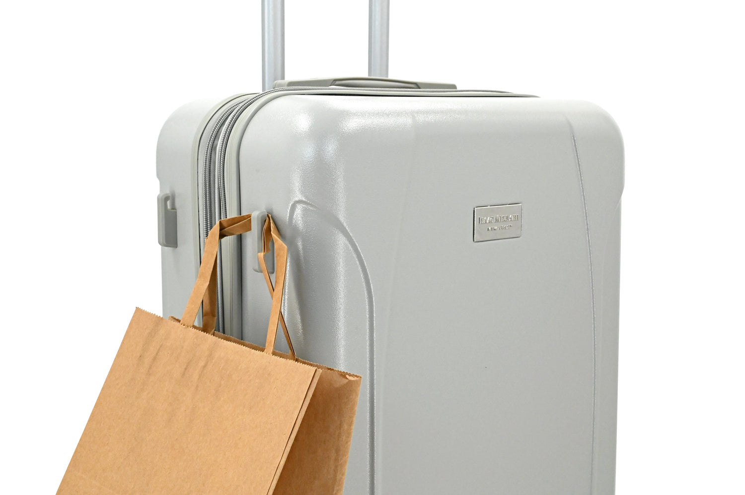 White suitcase with a brown paper bag attached on a white background