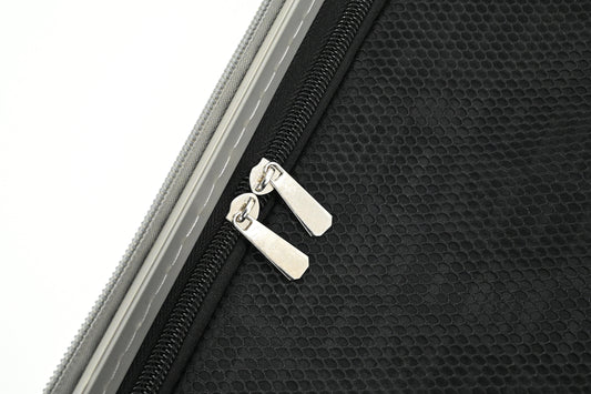 Set of three blue suitcases with wheels on a white background