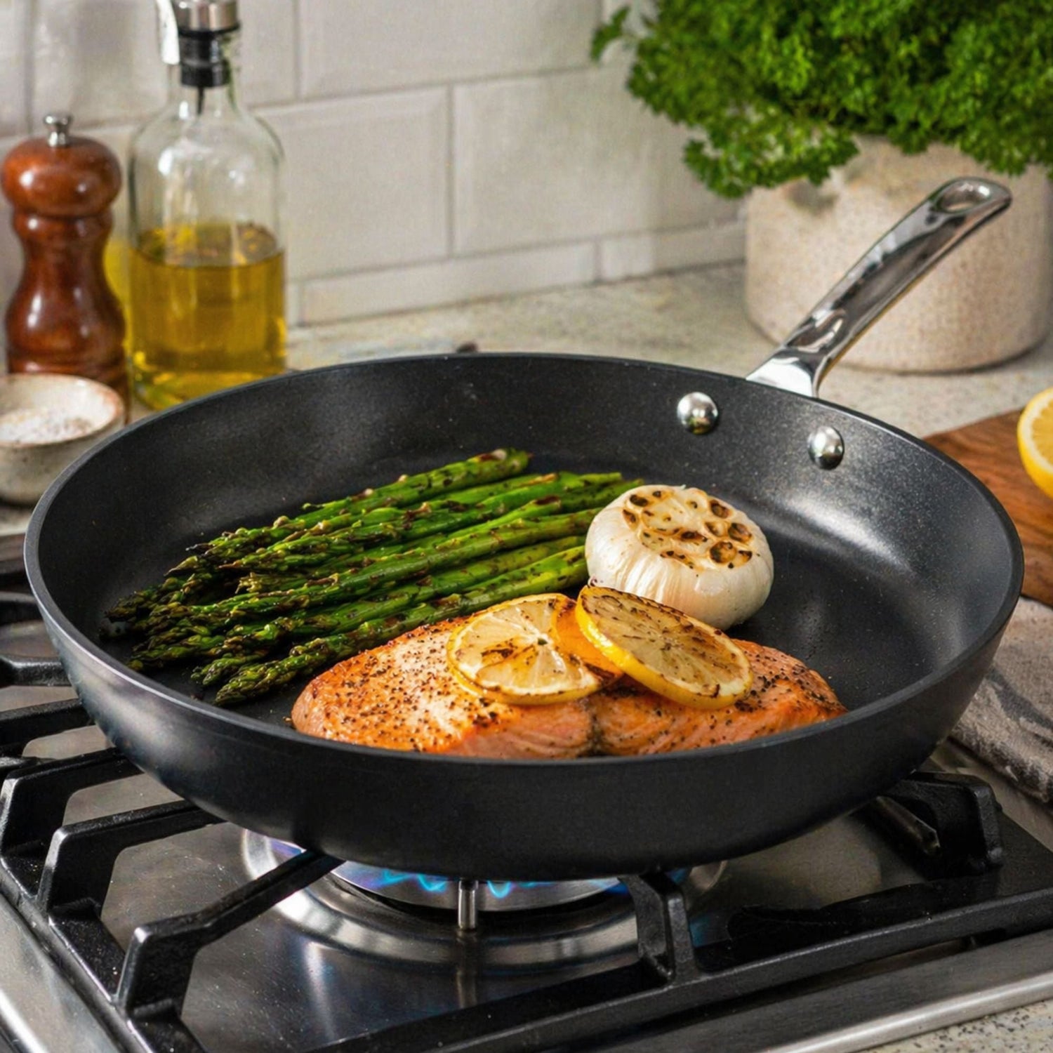 Frying pan with chicken, asparagus, and lemon on a stove