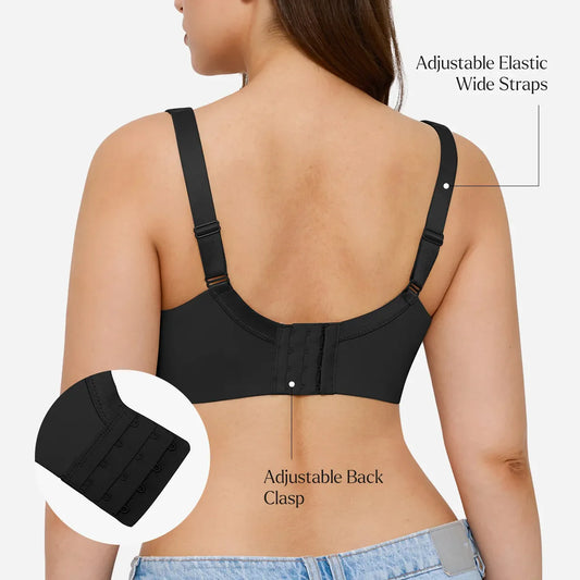 A woman modeling a black wireless underwire bra against a light gray studio background.