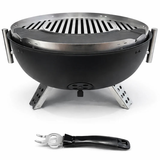 Portable grill with food being cooked on a wooden table outdoors