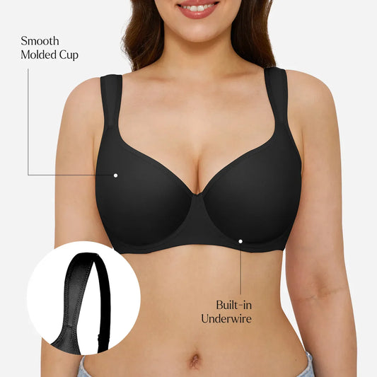 A woman modeling a black wireless underwire bra against a light gray studio background.