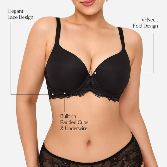 A woman modeling a black underwire bra with lace trim, styled with an open white shirt against a plain light background.