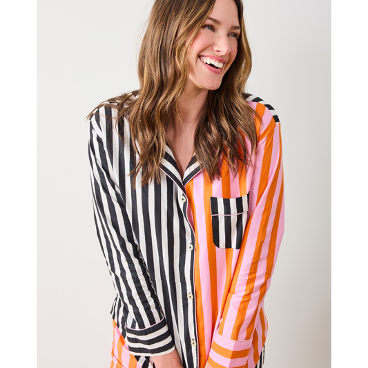 Woman wearing a colorful striped shirt against a white background