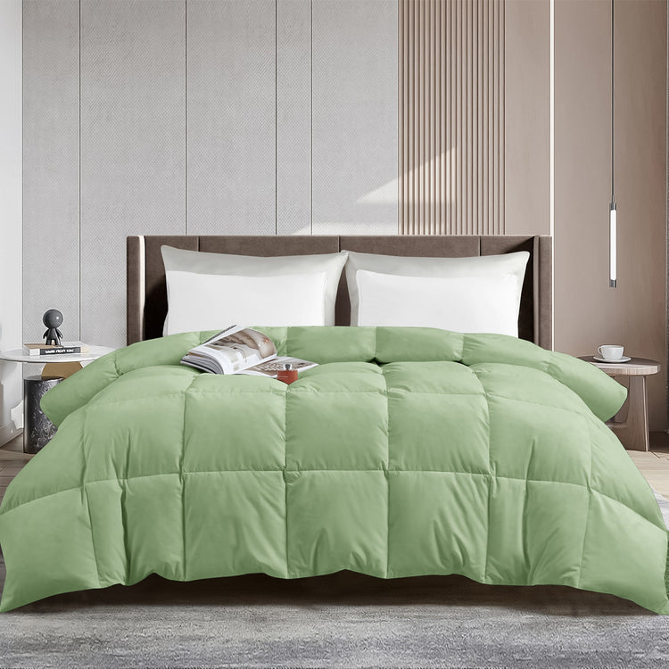 Green comforter on a bed in a modern bedroom setting