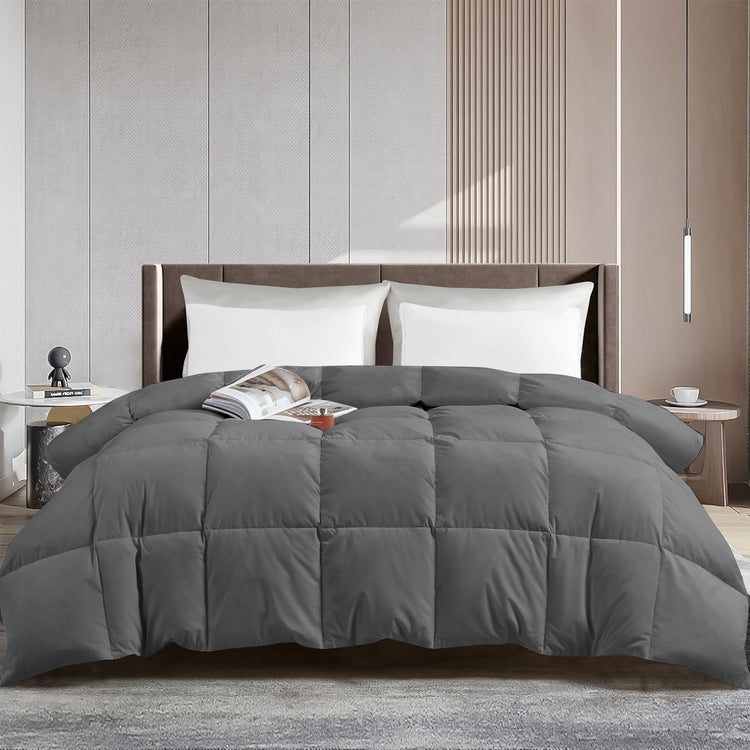 Gray comforter on a bed in a modern bedroom setting