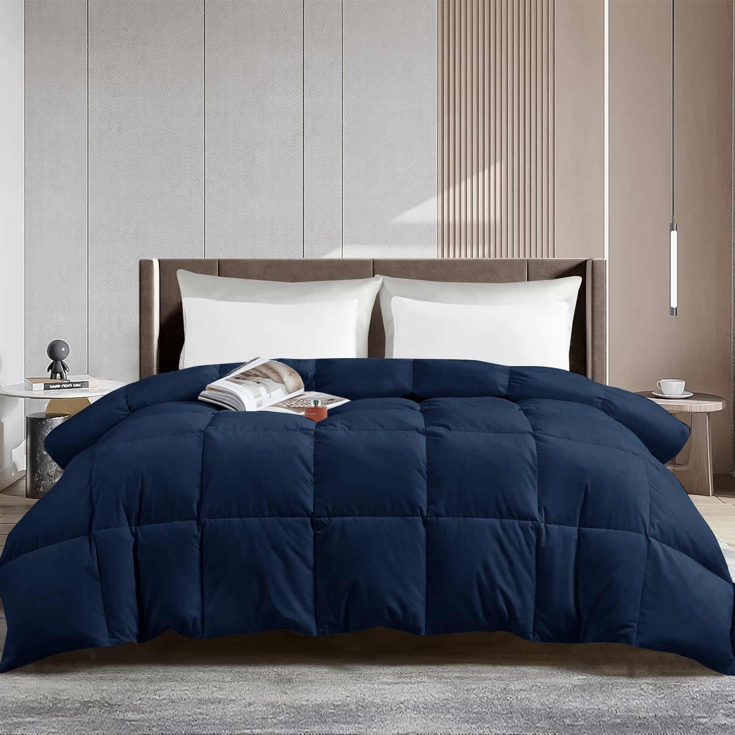 Navy blue comforter on a bed in a modern bedroom setting