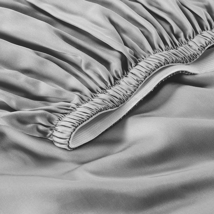 Close-up of a fitted sheet on a bed with a focus on the elastic band.