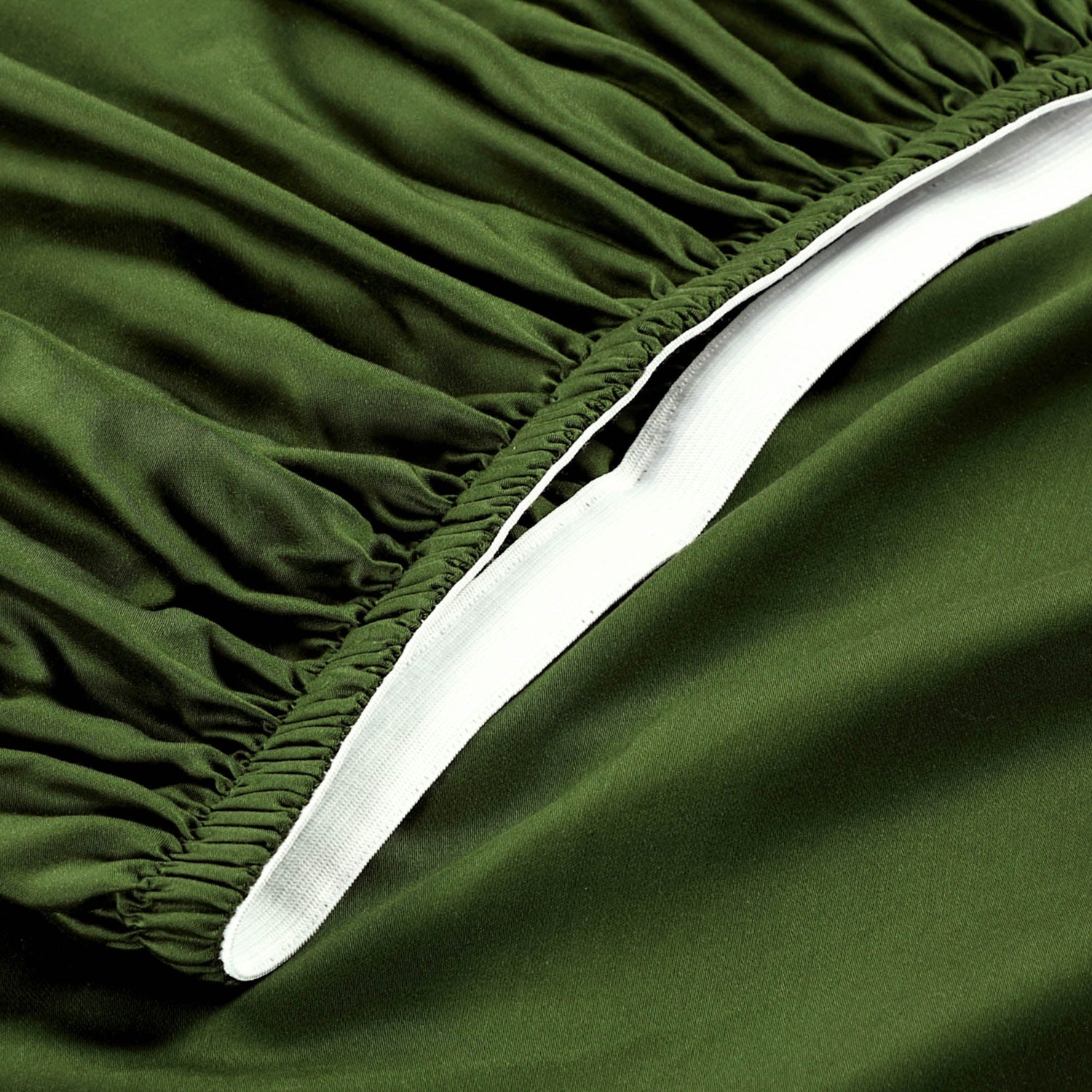 Close-up of green fitted sheet with white edge
