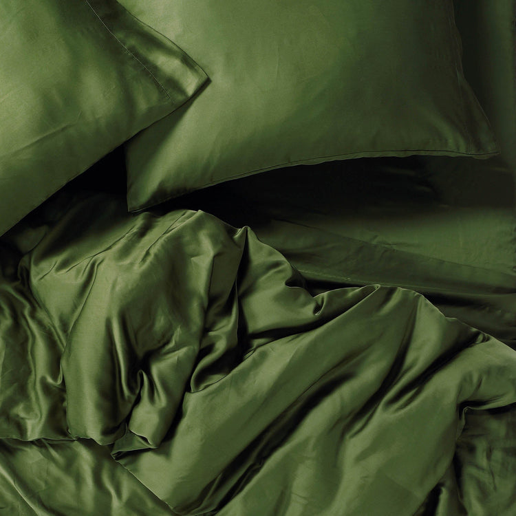 Green satin bedding set with pillows and duvet