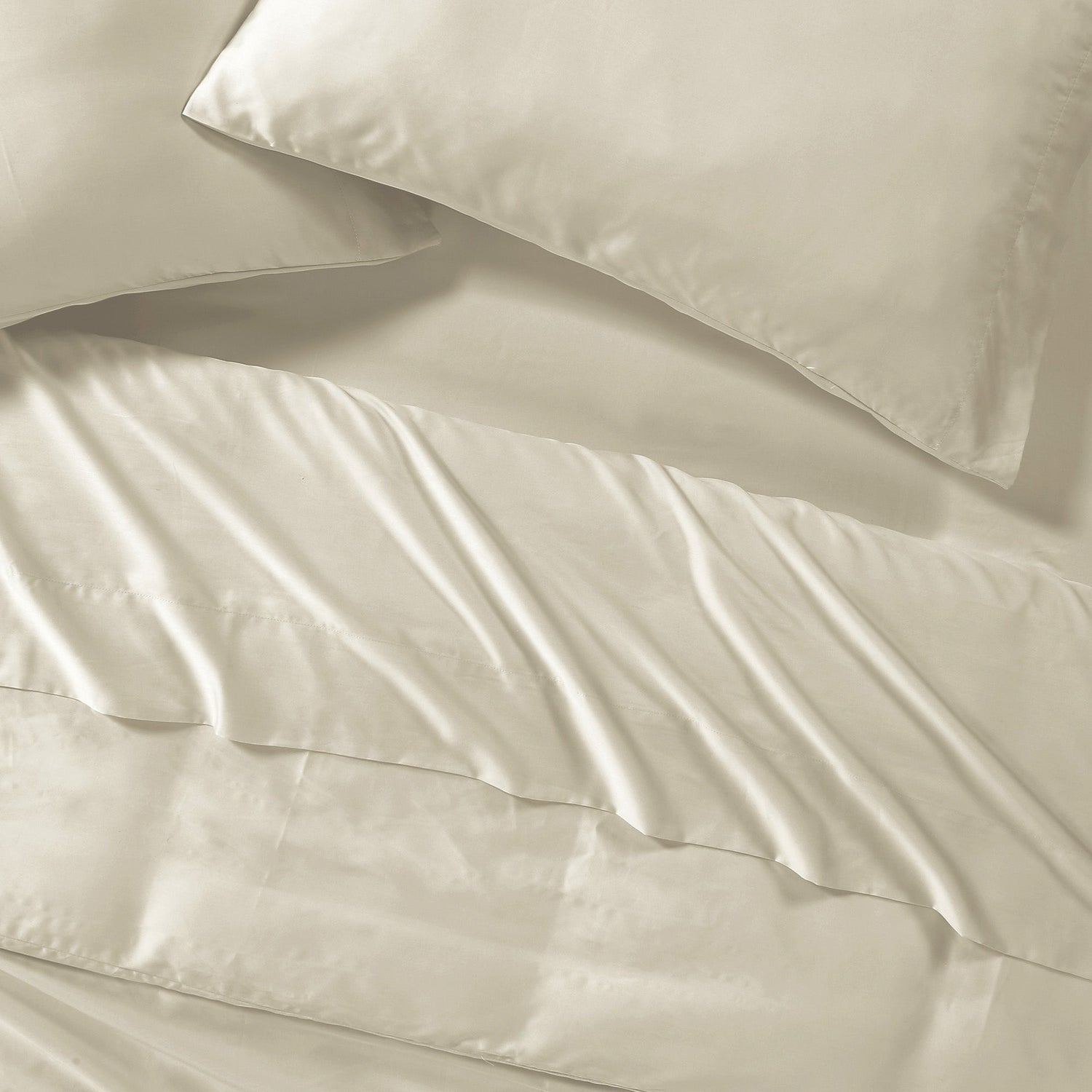 Beige satin pillowcases on a matching fabric background
