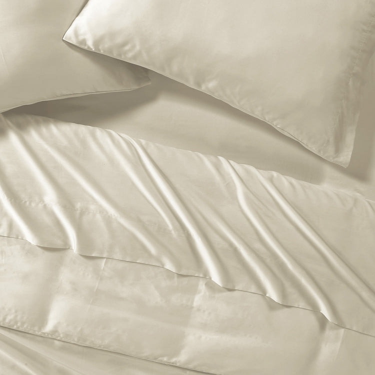 Beige satin pillowcases on a matching fabric background