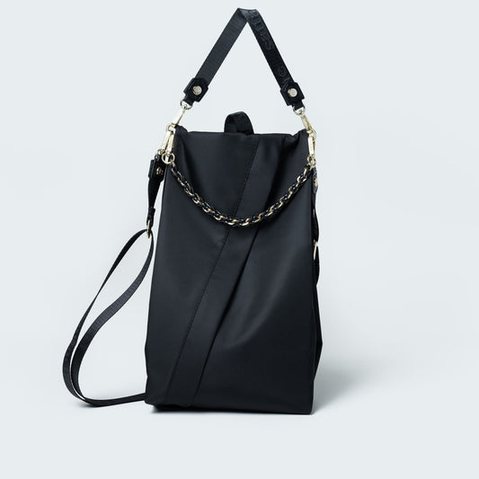 Black handbag with chain detail on a white background