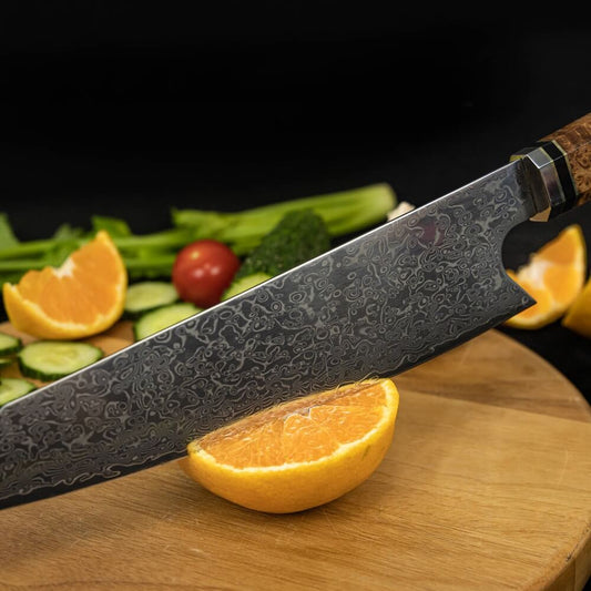Sakao Damascus kitchen knife with wooden handle and branded packaging on a white background