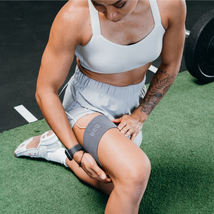 Person wearing a gray knee brace on a sports field