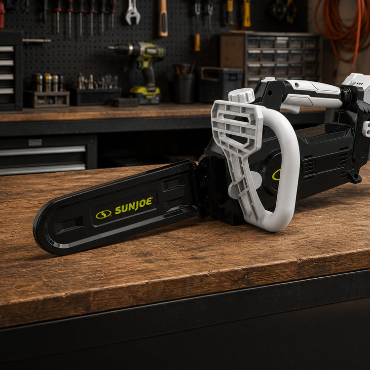 Sun Joe chainsaw on a wooden workbench with a workshop background