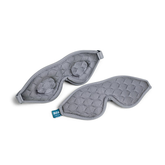 Gray quilted eye mask with a brand tag on a white background