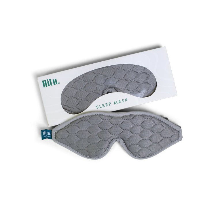 Gray quilted sleep mask with packaging on a white background