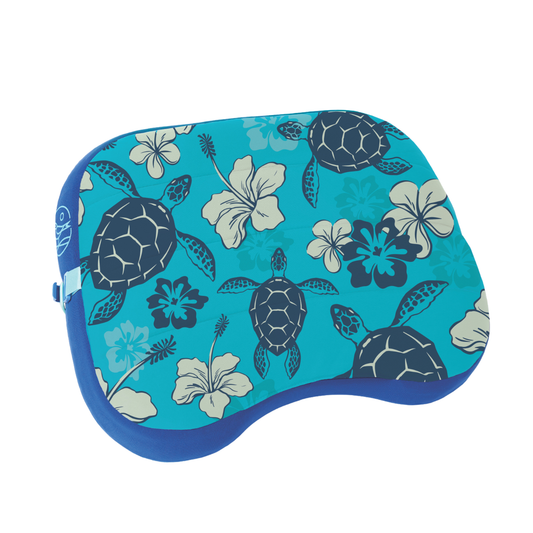 Blue pillow with turtle and floral pattern on a white background