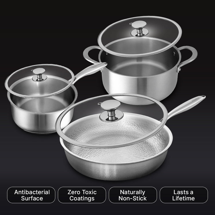 Set of stainless steel cookware with lids on a black background