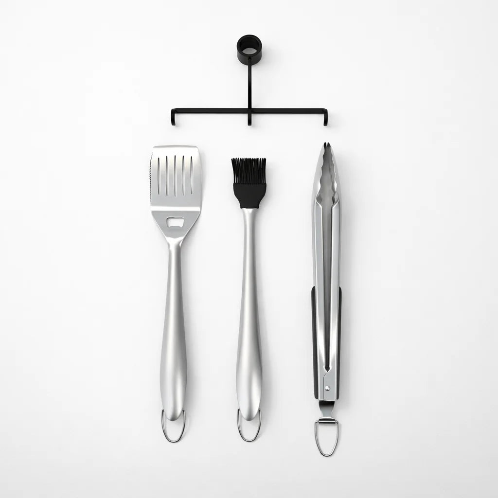Set of three metal barbecue tools on a white background