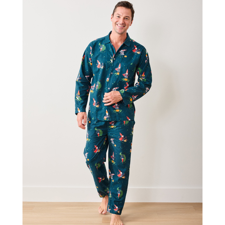 Man wearing a teal pajama set with animal print on a plain background
