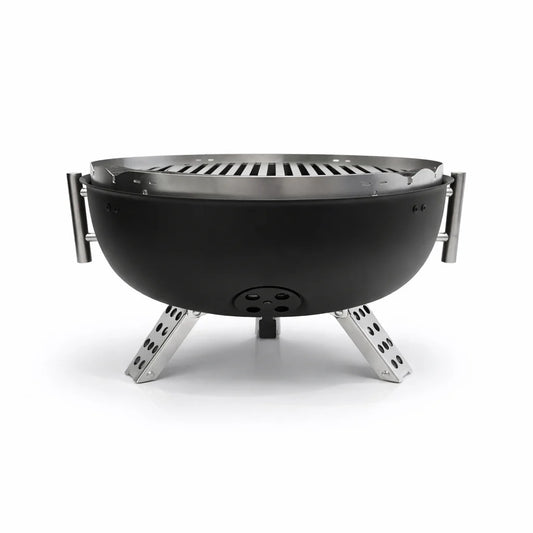 Portable grill with food being cooked on a wooden table outdoors