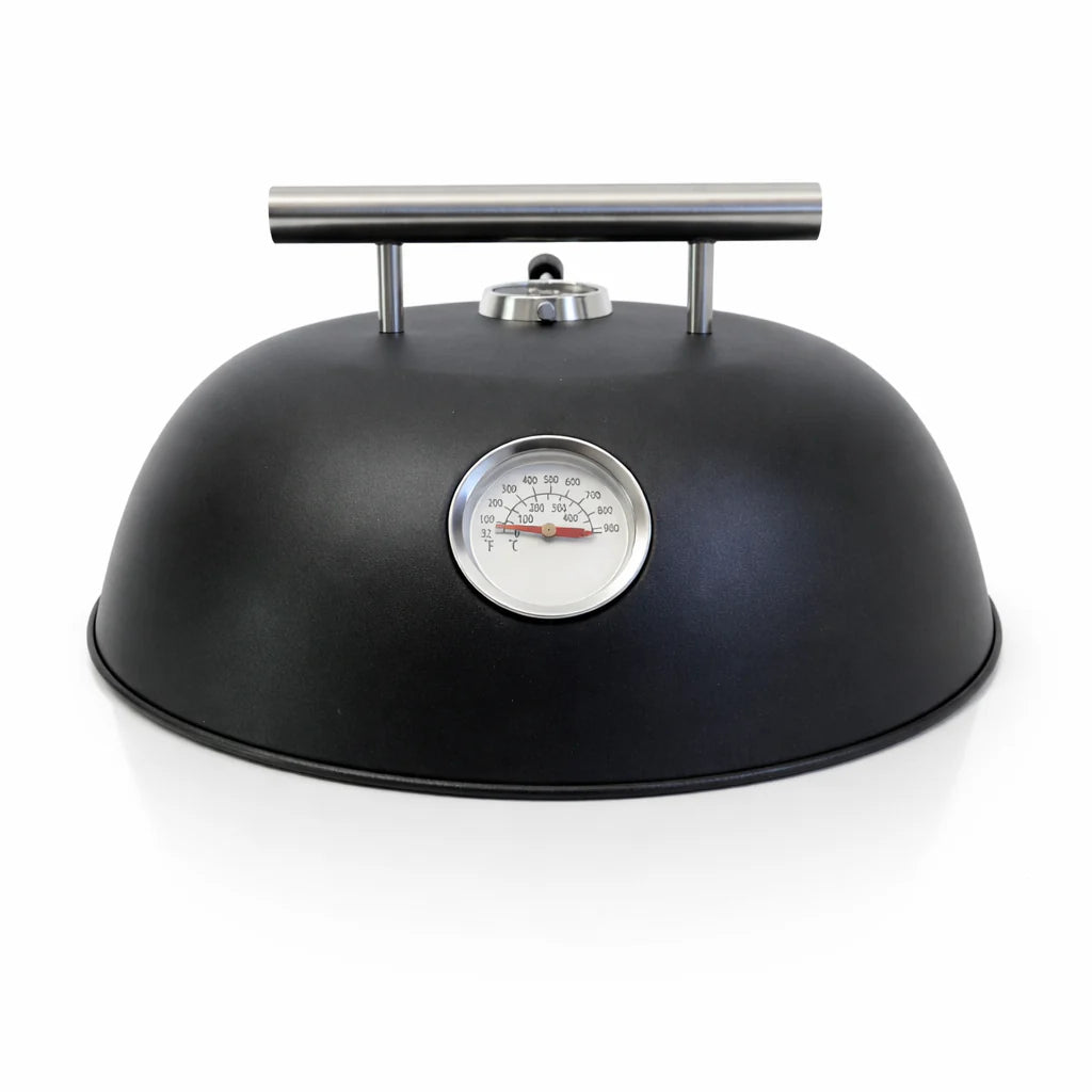Black dome-shaped pressure cooker with a thermometer on a white background