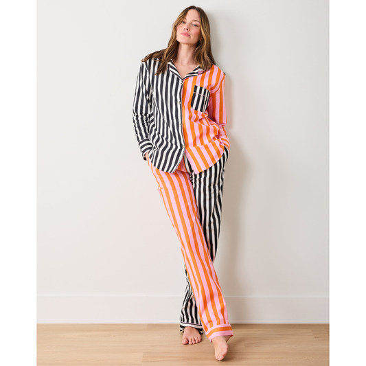 Woman wearing a colorful striped shirt against a white background