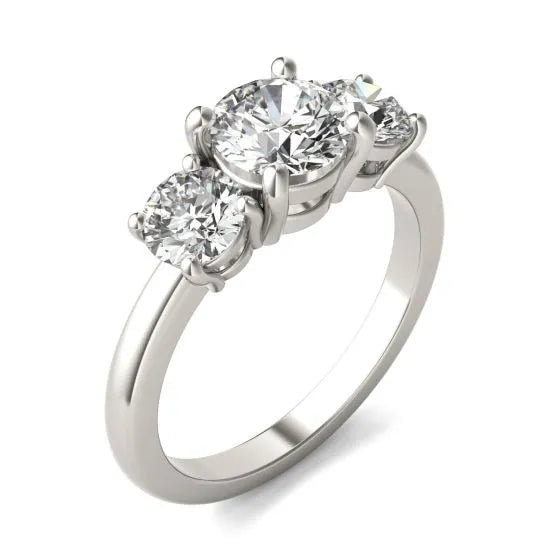 Diamond ring with three clear gemstones on a white background