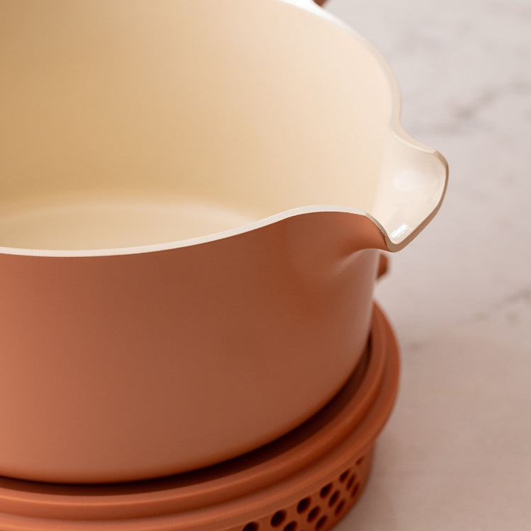 Stack of terracotta pots on a light surface