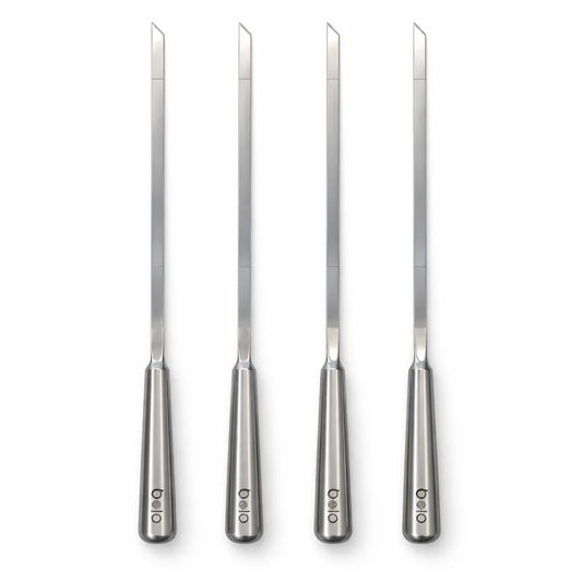 Black portable grill with metal skewers on a white background
