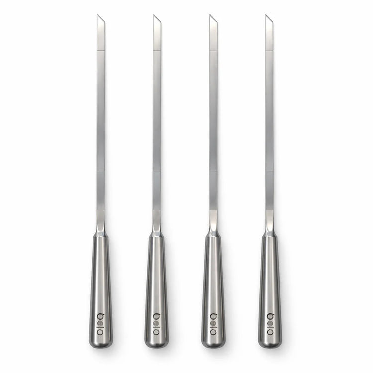 Set of four metal knives with handles on a white background