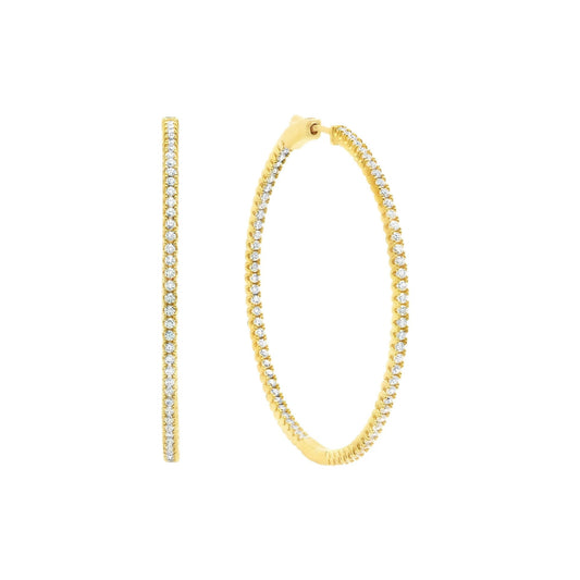 Gold hoop earrings with clear gemstones on a white background