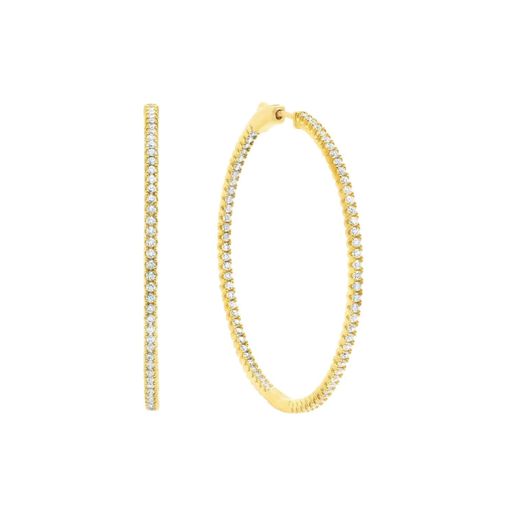 Gold hoop earrings with clear gemstones on a white background
