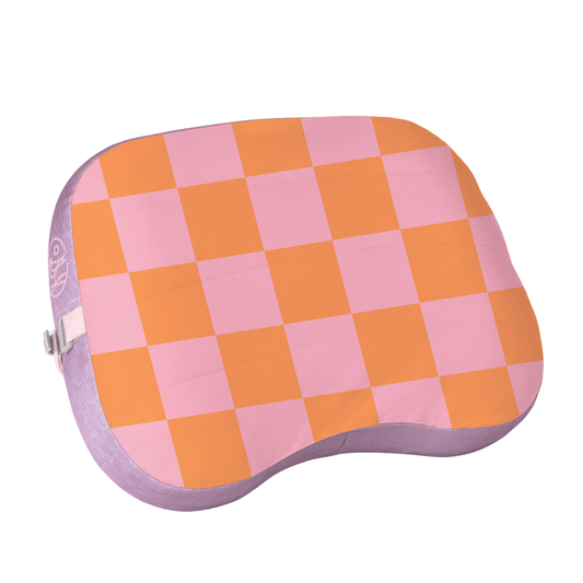 Checkered pink and orange cushion on a white background
