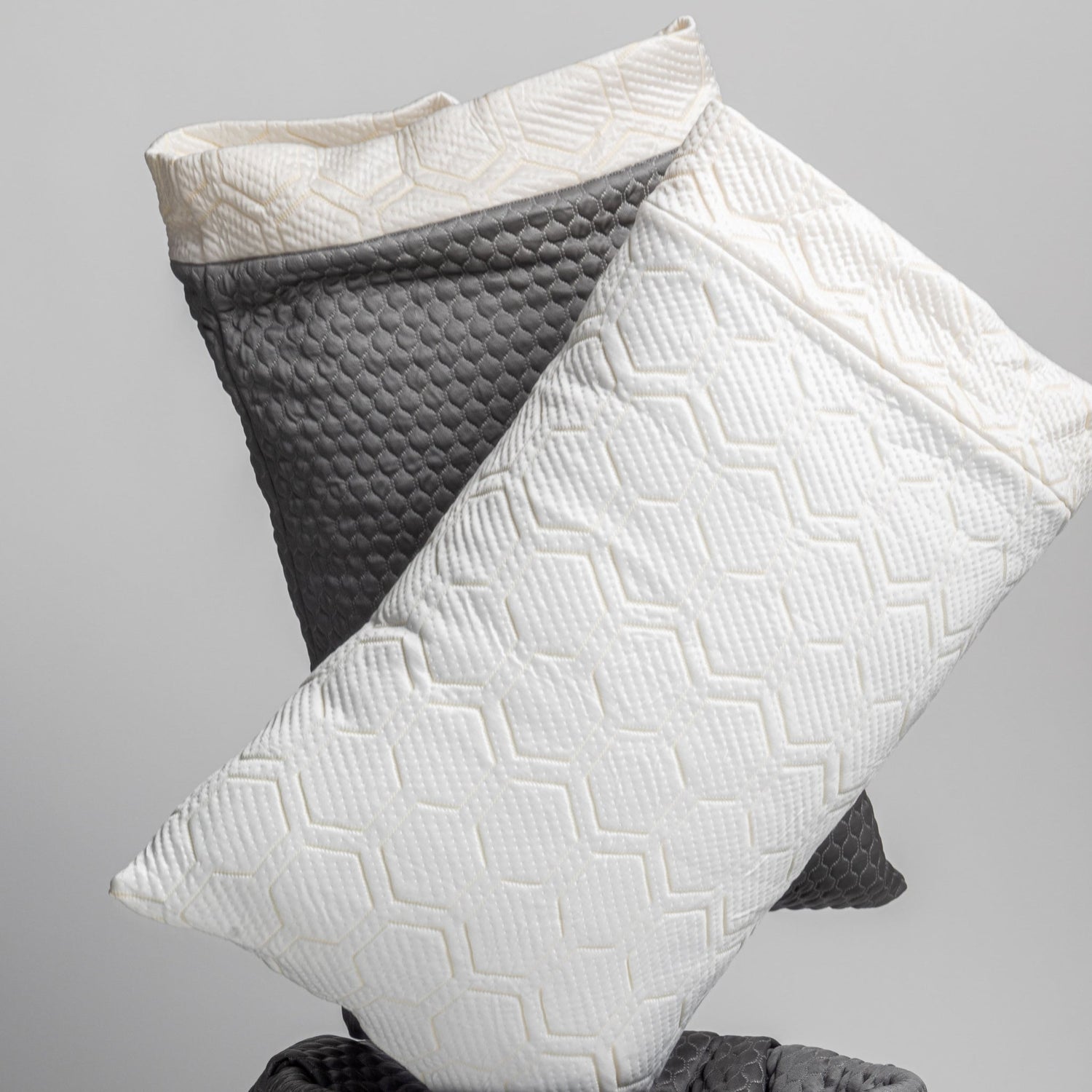 White and gray textured pillows on a light gray background