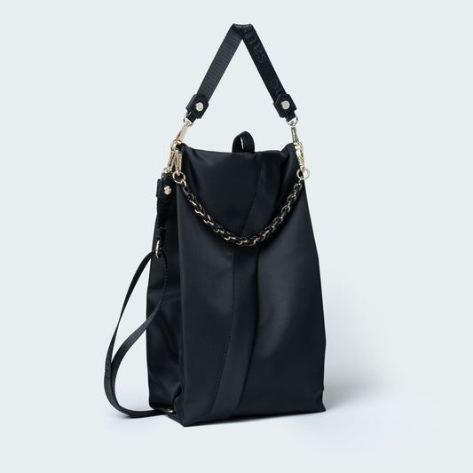 Black handbag with chain detail on a white background