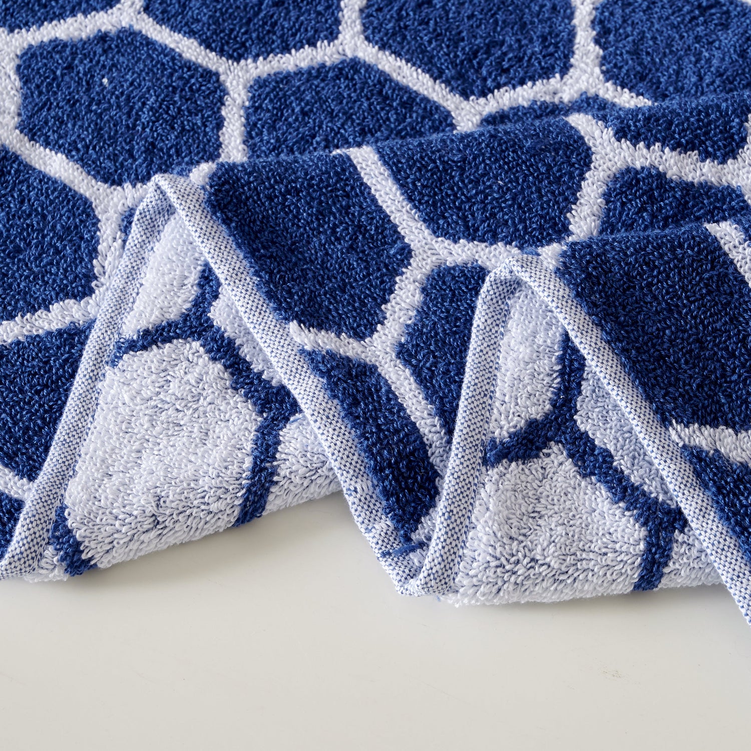 Blue and white geometric patterned rug on a light background