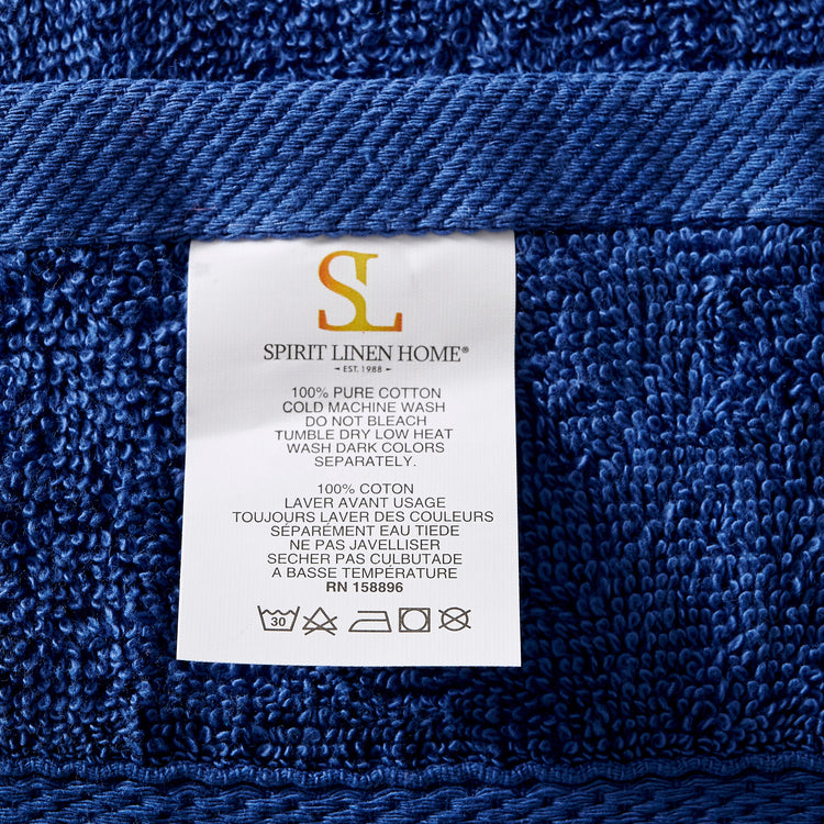 Blue towel with a Spirit Linen Home label showing care instructions.