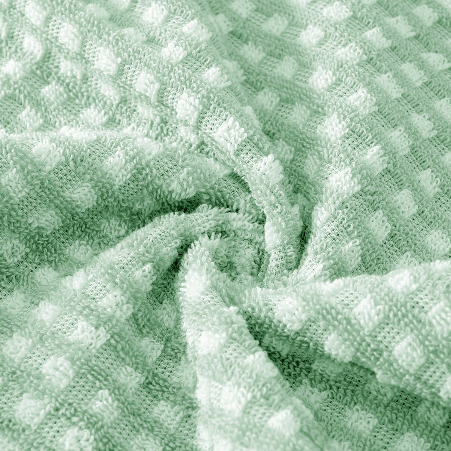 Close-up of textured green fabric with a waffle pattern
