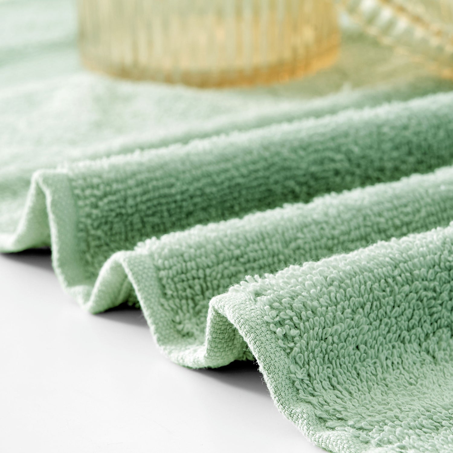 Green microfiber cloth on a light gray surface