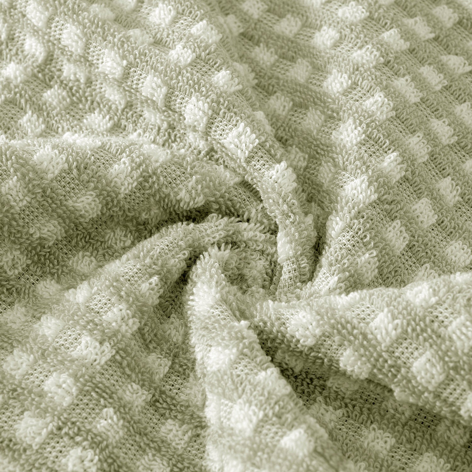 Close-up of textured green fabric with a waffle pattern