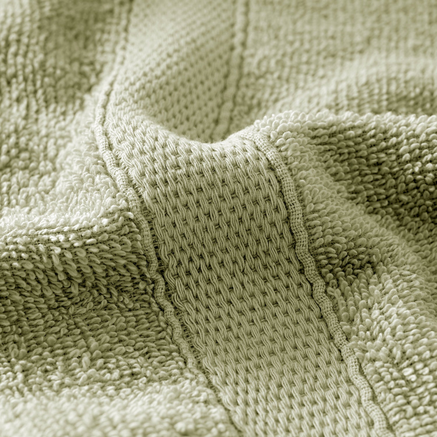 Close-up of a textured green fabric surface