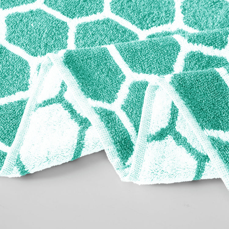 Green and white patterned fabric on a gray background