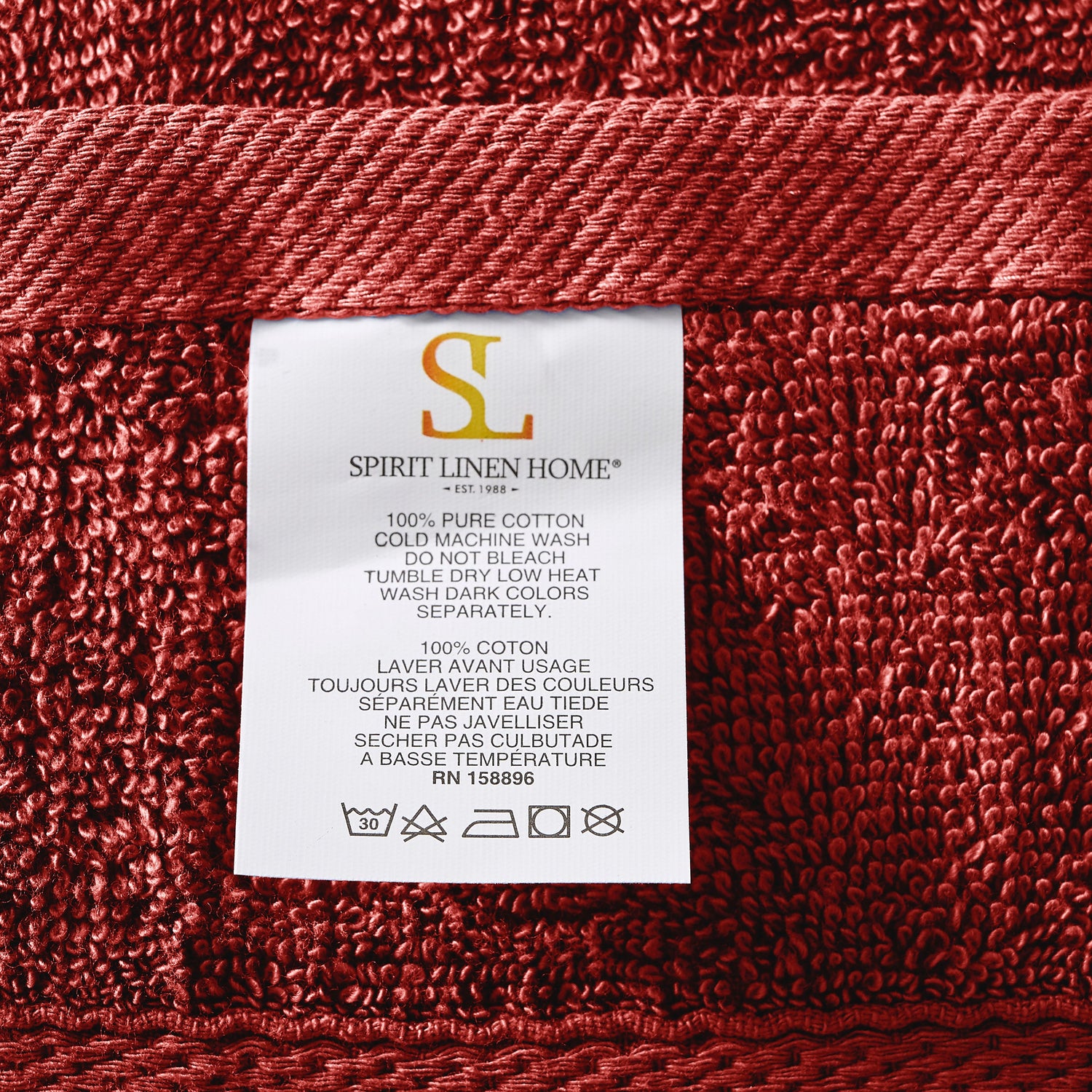 Red towel with a Spirit Linen Home label on a red background