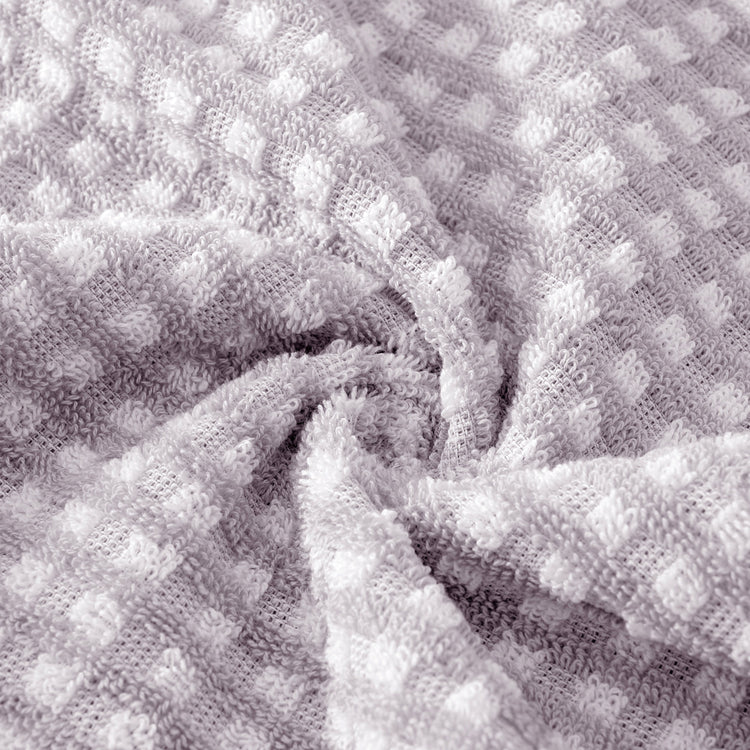 Close-up of textured gray fabric with a waffle pattern