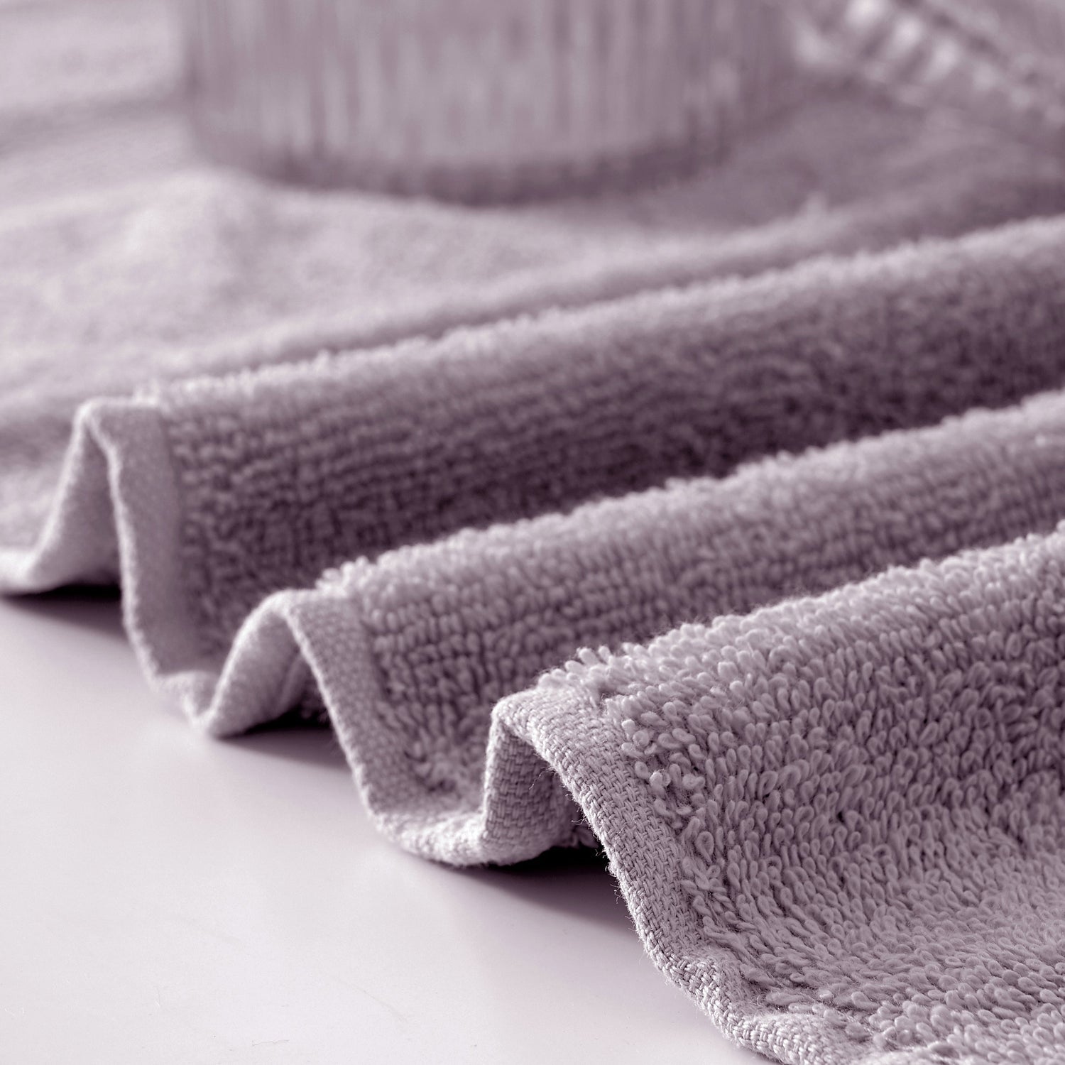 Stack of gray textured towels on a light surface