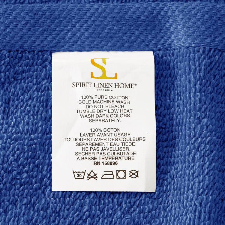 Fabric tag with 'Spirit Linen Home' branding on a blue textured fabric background